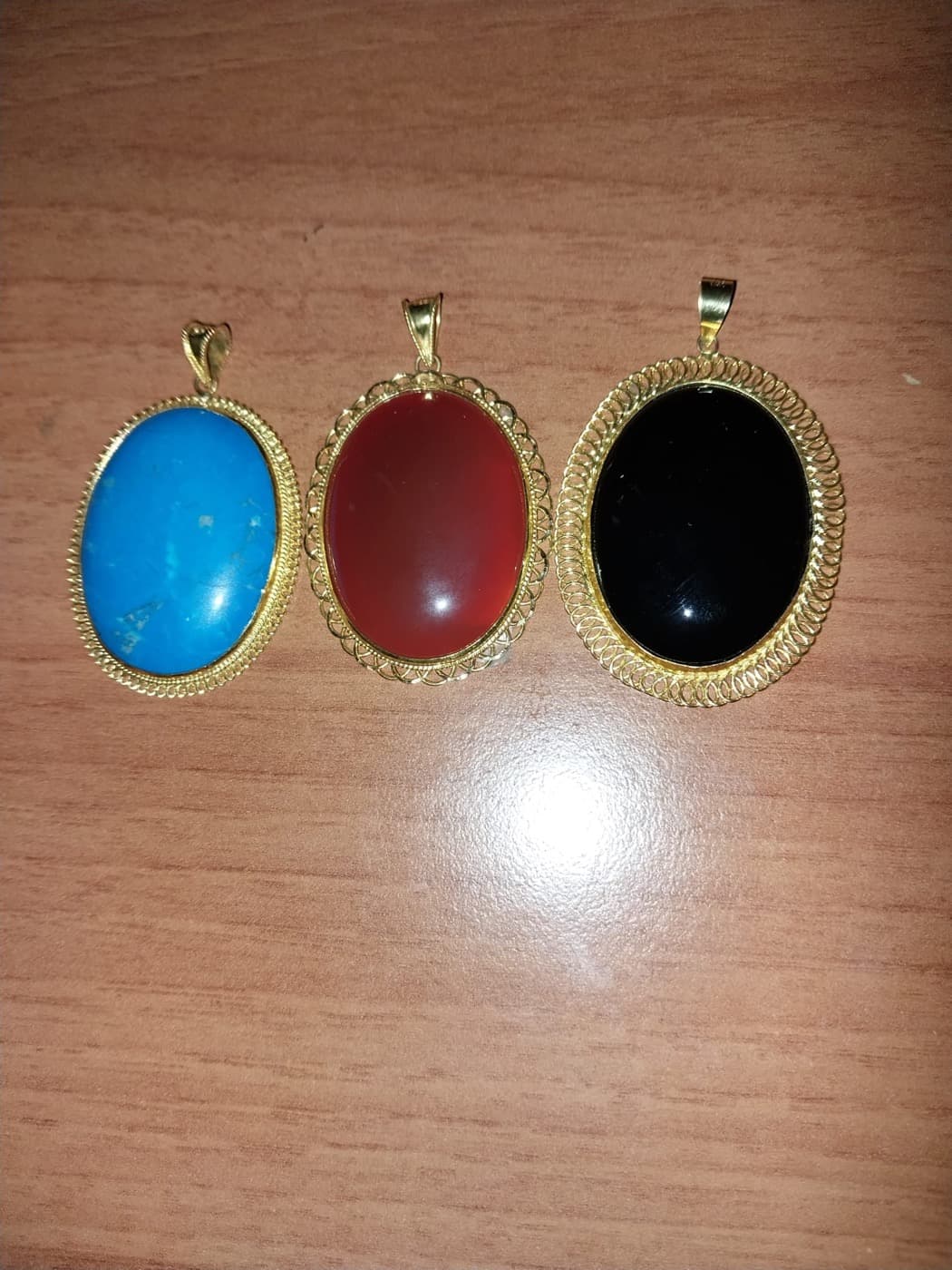 Gold pendants with natural stones